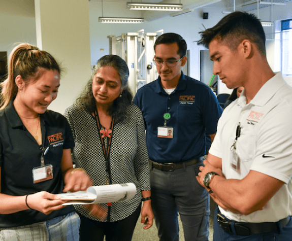 PT Professor with three students.